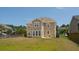 An exterior of the home shows it's large size, and backyard patio at 3274 Arrow Arum Dr, Johns Island, SC 29455