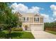 Charming two-story home featuring a well-manicured lawn, attached garage and a mix of brick and vinyl siding at 3274 Arrow Arum Dr, Johns Island, SC 29455