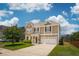 Charming two-story home featuring a well-manicured lawn, attached garage and a mix of brick and vinyl siding at 3274 Arrow Arum Dr, Johns Island, SC 29455