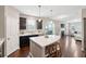 Open kitchen view with island seating and stainless steel appliances that flows into the living area at 3274 Arrow Arum Dr, Johns Island, SC 29455