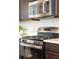 Close up view of a stainless steel range and microwave, complete with modern cabinets and countertops at 3274 Arrow Arum Dr, Johns Island, SC 29455