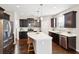 Well-equipped kitchen with stainless appliances, dark cabinets, an island with seating, and lots of natural light at 3274 Arrow Arum Dr, Johns Island, SC 29455