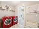 View of modern laundry room including side-by-side washer and dryer and decorating at 3274 Arrow Arum Dr, Johns Island, SC 29455