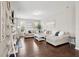 Cozy living room featuring a large sectional sofa, hardwood floors, and bright natural light from the windows at 3274 Arrow Arum Dr, Johns Island, SC 29455