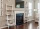 Living room showcasing a fireplace, ladder shelving, and a mounted television at 3274 Arrow Arum Dr, Johns Island, SC 29455