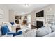 Open concept living room featuring hardwood floors, a fireplace, and an adjacent kitchen at 3274 Arrow Arum Dr, Johns Island, SC 29455