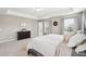 Serene main bedroom showcasing a large bed, tray ceilings, and neutral decor at 3274 Arrow Arum Dr, Johns Island, SC 29455