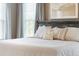 Comfortable king-size bed in a main bedroom with soft bedding and lots of pillows at 3274 Arrow Arum Dr, Johns Island, SC 29455