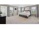 Spacious main bedroom with a large bed, tray ceiling, and plenty of natural light from multiple windows at 3274 Arrow Arum Dr, Johns Island, SC 29455