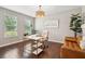 Well-lit home office with hardwood floors, a contemporary desk, stylish chair, and large windows at 3274 Arrow Arum Dr, Johns Island, SC 29455