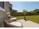 A small patio with two wicker chairs faces a lush green yard at 3274 Arrow Arum Dr, Johns Island, SC 29455