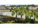 A lush pond view from the yard, lined with palm trees, flowers, and a wooden fence at 3274 Arrow Arum Dr, Johns Island, SC 29455