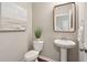 Elegant powder room features a pedestal sink, decorative mirror, and neutral wall color at 3274 Arrow Arum Dr, Johns Island, SC 29455
