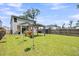 Expansive backyard with a pergola, lush green lawn, and a privacy fence, ideal for entertaining at 331 Saddlewood Dr, Charleston, SC 29414