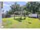 Inviting backyard with a pergola, manicured lawn, and a storage shed, creating a serene outdoor retreat at 331 Saddlewood Dr, Charleston, SC 29414