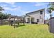 Spacious backyard with a pergola, storage shed, and a well-maintained lawn, perfect for outdoor activities at 331 Saddlewood Dr, Charleston, SC 29414
