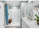 This bathroom features a white shower and a single sink with a white countertop and an ornate flower centerpiece at 331 Saddlewood Dr, Charleston, SC 29414