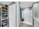 Bathroom boasting a step-in shower with a blue shower curtain and an adjacent walk-in closet with multiple shelving units at 331 Saddlewood Dr, Charleston, SC 29414