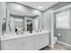 Bright bathroom showcasing double sinks, a large mirror, and tile flooring with an adjacent toilet and a view into the bedroom at 331 Saddlewood Dr, Charleston, SC 29414