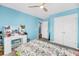 Bright blue bedroom featuring a vanity, floral bedding, and closets at 331 Saddlewood Dr, Charleston, SC 29414