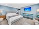 Light and airy bedroom featuring light blue walls and a wall-mounted television above a light blue table at 331 Saddlewood Dr, Charleston, SC 29414