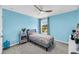Light blue bedroom featuring a gray upholstered bed and a window at 331 Saddlewood Dr, Charleston, SC 29414