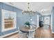 Cozy dining room with a round table, white chairs, and a modern chandelier at 331 Saddlewood Dr, Charleston, SC 29414