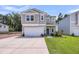 Charming two-story home with light gray siding, a manicured lawn, and a welcoming blue front door at 331 Saddlewood Dr, Charleston, SC 29414