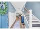 Light and bright foyer with blue walls, wood floors, and a staircase with black iron spindles at 331 Saddlewood Dr, Charleston, SC 29414