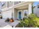 Inviting front porch with a teal door, white columns, landscaping, and a two-car garage at 331 Saddlewood Dr, Charleston, SC 29414