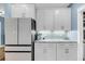 Kitchen details showcasing white cabinets, stone countertops, and stainless steel refrigerator at 331 Saddlewood Dr, Charleston, SC 29414