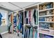 A fully stocked walk-in closet with installed racks and shelves that line the walls and filled with clothing items at 331 Saddlewood Dr, Charleston, SC 29414