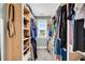 Well-lit walk-in closet featuring carpeted floors, shelving on both sides, and a window at 331 Saddlewood Dr, Charleston, SC 29414