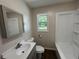 Bathroom featuring a vanity, toilet and tub-shower combo at 365 W Pine St, Varnville, SC 29944