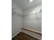 Walk-in closet offering organized storage space with shelves and a bench, ready for efficient organization at 365 W Pine St, Varnville, SC 29944