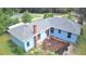 Aerial view of home highlighting a new gray roof, light blue siding, and space for landscaping in the backyard at 365 W Pine St, Varnville, SC 29944