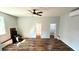 Spacious living room with wood-look floors, a unique vintage wood burning stove, and bright, neutral-colored walls at 365 W Pine St, Varnville, SC 29944