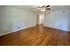Bright living room with gleaming hardwood floors and a ceiling fan at 365 W Pine St, Varnville, SC 29944