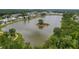 Aerial view of a serene lake surrounded by lush greenery and community homes at 3769 Summerton St, Mount Pleasant, SC 29466