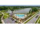 Aerial view showcases a community pool, lake, and surrounding lush landscape at 3769 Summerton St, Mount Pleasant, SC 29466