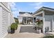 Charming backyard with a covered patio, outdoor hot tub, and lush greenery, perfect for relaxation at 3769 Summerton St, Mount Pleasant, SC 29466