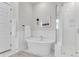 Bright bathroom features a soaking tub, glass-enclosed shower, and modern white fixtures at 3769 Summerton St, Mount Pleasant, SC 29466