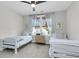 Bright bedroom featuring two twin beds, stylish decor, ceiling fan, and a window for ample natural light at 3769 Summerton St, Mount Pleasant, SC 29466
