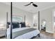 Spacious bedroom with a four poster bed, hardwood floors, and access to the bathroom at 3769 Summerton St, Mount Pleasant, SC 29466
