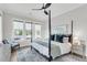 Bright bedroom features a four poster bed, ceiling fan, and large windows with a view at 3769 Summerton St, Mount Pleasant, SC 29466
