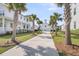Long driveway leads to a lovely two-story home with a detached garage surrounded by palm trees at 3769 Summerton St, Mount Pleasant, SC 29466