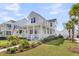 Attractive two-story home with a inviting front porch, manicured lawn, and palm trees at 3769 Summerton St, Mount Pleasant, SC 29466