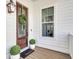 Charming front entrance with a dark wooden door, decorative wreath, and inviting 