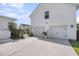 Three-car garage with white exterior, black hardware, and a concrete driveway, offering ample parking at 3769 Summerton St, Mount Pleasant, SC 29466