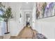 Bright hallway with wainscoting, a decorative tree, and an entry door with glass at 3769 Summerton St, Mount Pleasant, SC 29466